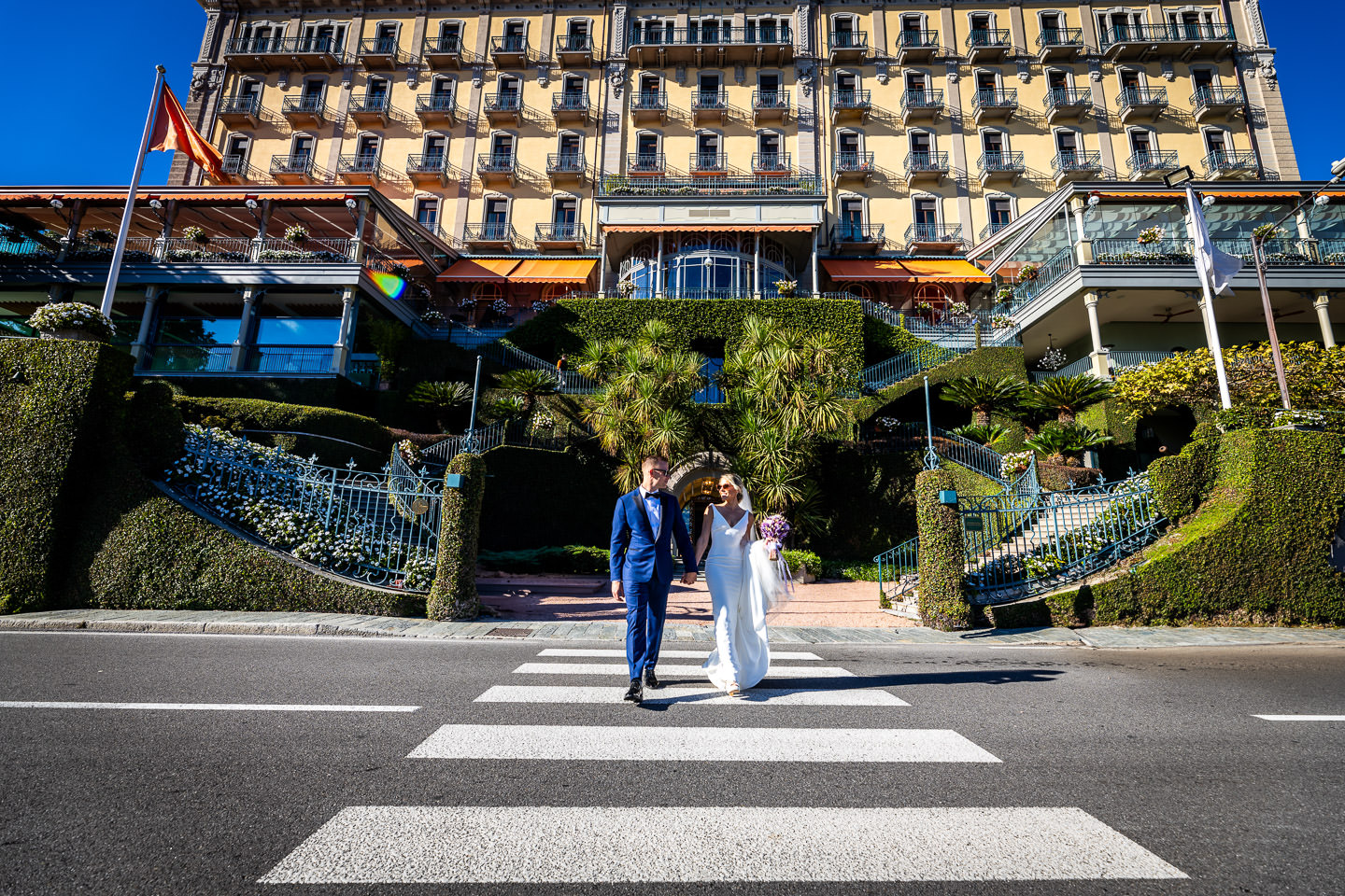 bride and groom in front of the hotel tremezzo como