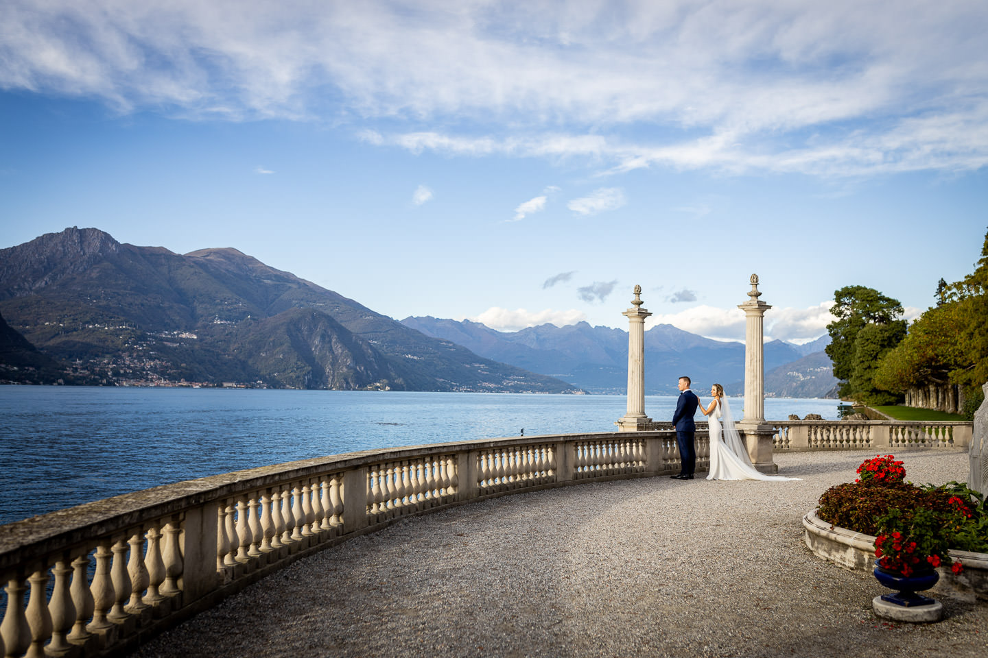 bride and groom walking in front of villa melzi bellagio como