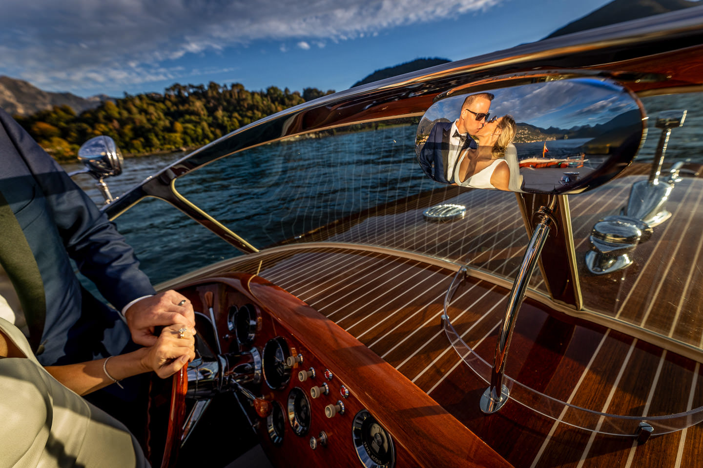 bride and groom in boat on lake como