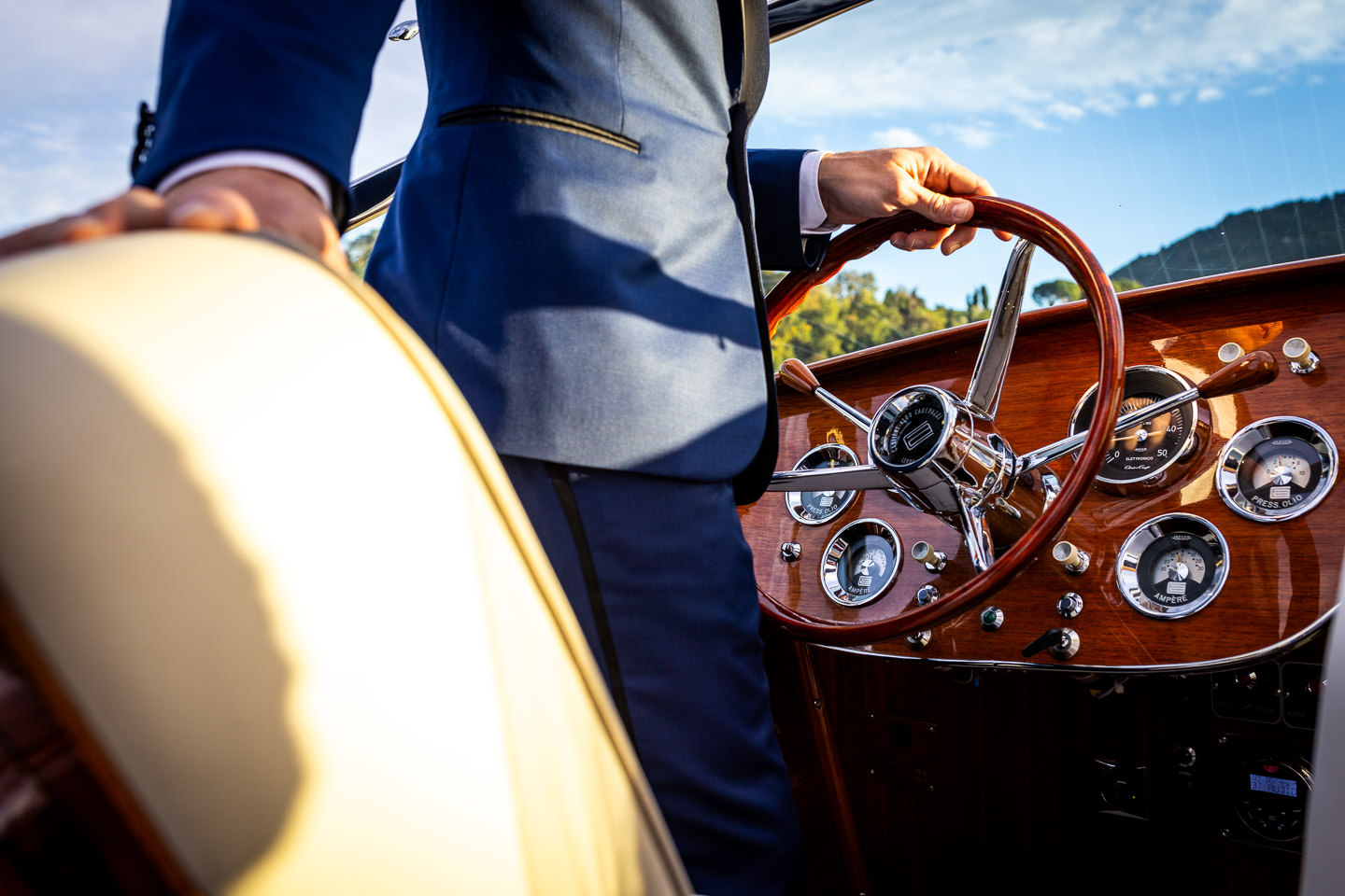 bride and groom in boat on lake como sunset in background